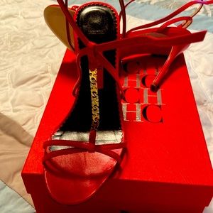 Gorgeous Carolina Herrera red sandal heels with gold Carolina Herrera links.